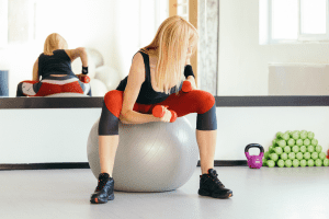 Fit Woman Doing Dumbbell Exercise