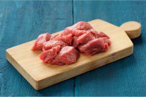 Raw lean meat cuts on wooden board