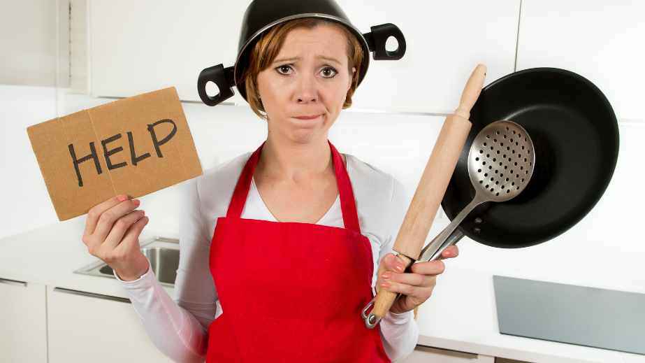 a woman in the kitchen asking for help