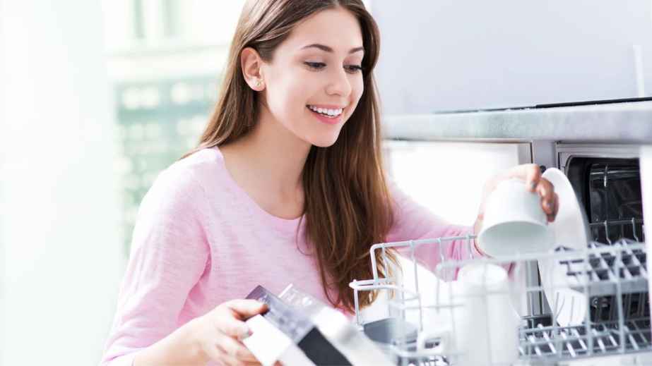 woman loading a dishwasher
