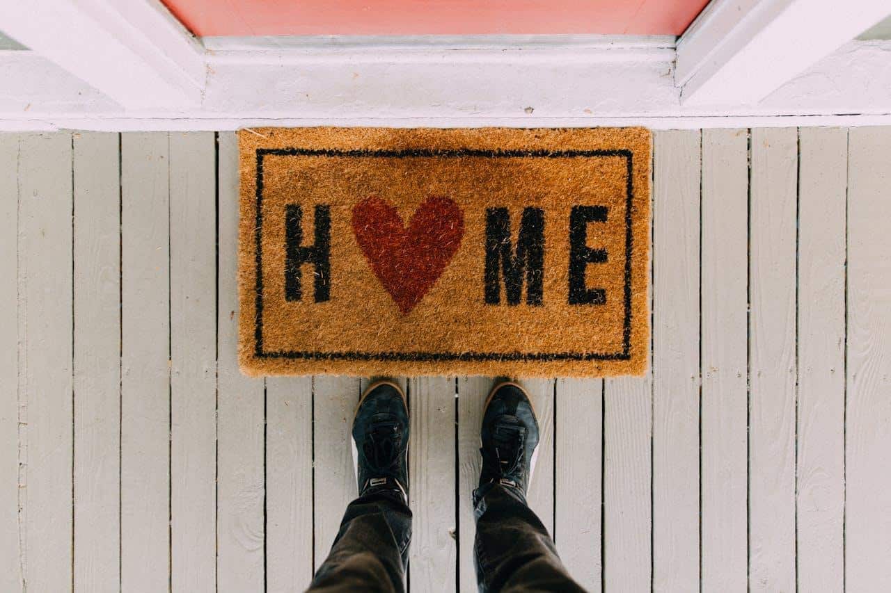 entryway rug with home sign.